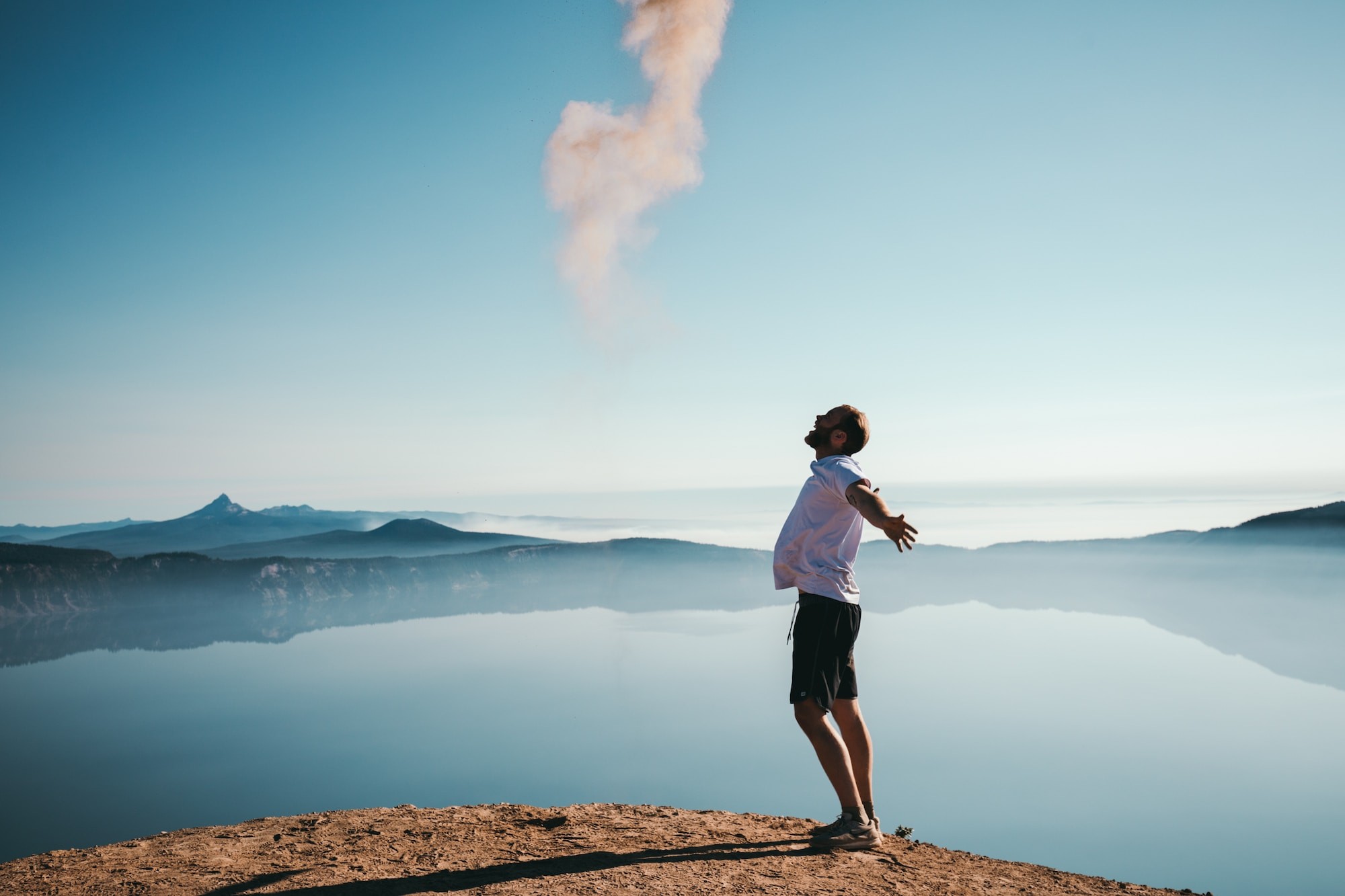 $0 Out-of-Pocket Cost text with a person standing with arms open toward the sky